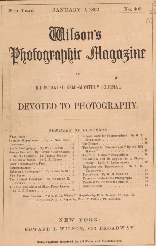 Wilson's photographic magazine, magazine, publisher: Edward Livingston Wilson, New York (city), 1892-01-02, Edward Livingston Wilson, publisher, North America, paper, printing, autotype, printing block, albumen print, height 254 mm x width 175 mm x thickness 4 mm, A single aged magazine cover printed on tan paper with a decorative ornate masthead near the top and a centered large bold headline below it, followed by a short line of small caps text and a larger bold tagline. Below that is a thin horizontal rule and a two-column list of items separated by a vertical rule, each column containing multiple short lines of printed entries. The paper shows slight discoloration and small blemishes, and margins are visible on all sides with a thin border line near the edges. The bottom portion includes a centered block of larger text above a final faint horizontal rule and a small line of fine print along the lower edge.