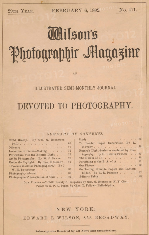 Wilson's photographic magazine, magazine, publisher: Edward Livingston Wilson, New York (city), 1892-02-06, Edward Livingston Wilson, publisher, North America, paper, printing, autotype, printing block, albumen print, height 256 mm x width 174 mm x thickness 4 mm, The image shows a vintage magazine cover with a pale peach background and a thin dark border, ornate blackletter title near the top, a centered subtitle in a serif typeface beneath it, and a large bold line of text below that. Below the main heading is a horizontal rule and a centered section heading followed by two narrow columns of small serif text, each column separated by a thin vertical rule, and a centered line of smaller text beneath the columns. Near the bottom is a wide area with a city name in large spaced serif letters and a publisher line in bold serif type, with additional small text along the very bottom. The page shows slight discoloration, foxing spots, and faint creases.