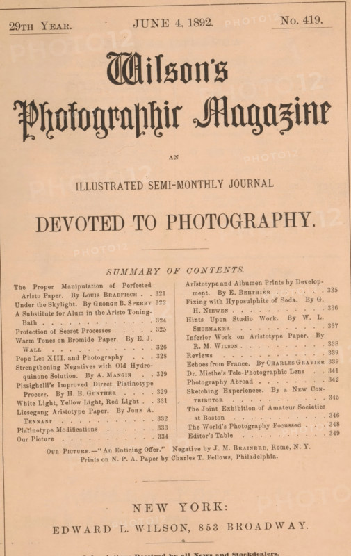 Wilson's photographic magazine, magazine, publisher: Edward Livingston Wilson, New York (city), 1892-06-04, Edward Livingston Wilson, publisher, North America, paper, printing, wood engraving, autotype, albumen print, height 255 mm x width 175 mm x thickness 4 mm, The image shows the upper portion of a printed periodical page on aged beige paper with a decorative masthead in a dark ornate typeface centered near the top and a large bold headline beneath it; beneath the headline is a horizontal rule and a centered subheading in smaller type. The page is divided into two narrow columns of body text made up of short entries with varied line lengths and small decorative separators, separated by a vertical space; the left column is aligned to the left margin and the right column to the right margin. A thin rectangular border runs near the outer edges of the page, and faint creases and small spots are visible on the paper surface. Near the lower portion of the visible area there is a wider ho...