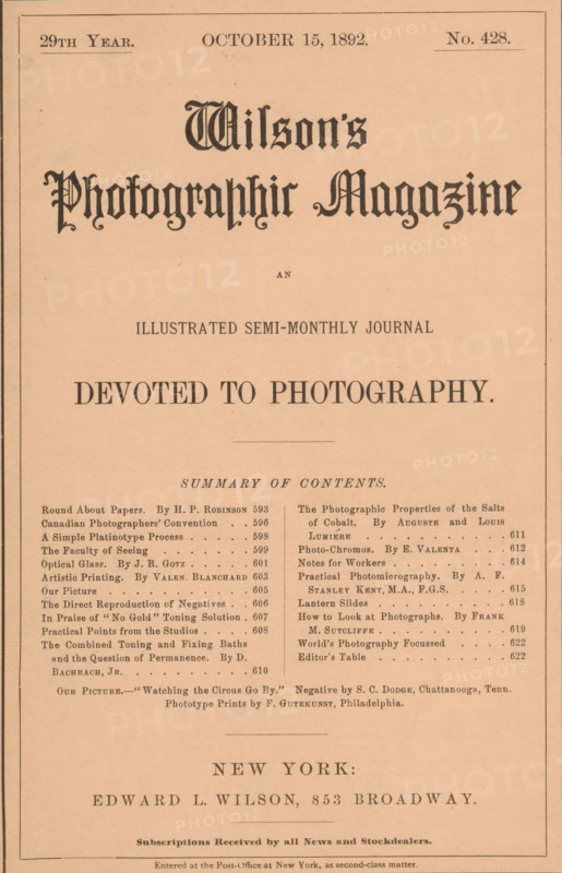 Wilson's photographic magazine, magazine, publisher: Edward Livingston Wilson, New York (city), 1892-10-15, Edward Livingston Wilson, publisher, North America, paper, printing, wood engraving, autotype, collotype, height 257 mm x width 178 mm x thickness 4 mm, A rectangular page with a light peach background framed by thin black lines, featuring ornate large dark gothic lettering near the top and several lines of smaller printed headings and columns below, a centered bold phrase in larger dark type midway down, two narrow columns of smaller printed lines and short paragraphs beneath that, decorative horizontal rules separating sections, and a wide line of bold type near the lower third above a final block of small printed lines at the bottom.