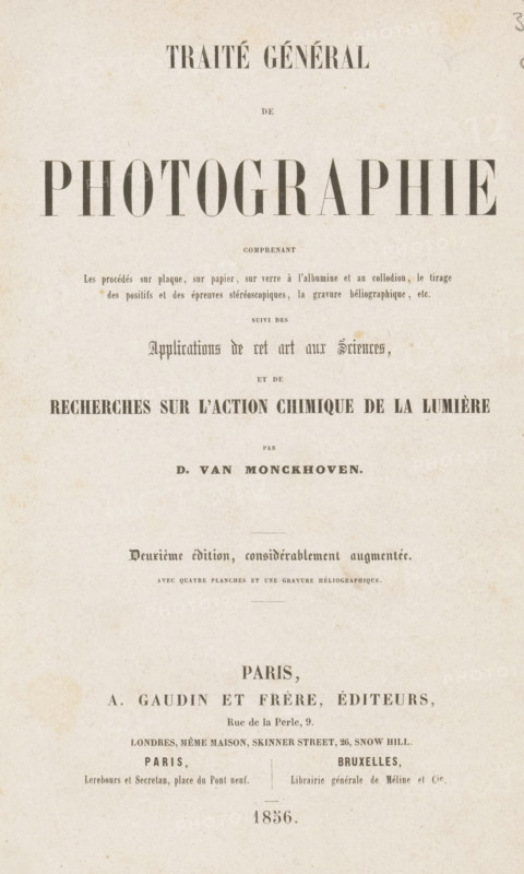 Traité général de photographie, book, inscription: 'Ma ... delapart del'Auteur D. van Monckhoven', publisher: A. Gaudin & frères, Paris, Brussels, 1856, A. Gaudin & frères, publisher, pasteboard, paper, printing, photoaquatint, veined marbled paper, agate marbled paper, height 235 mm x width 155 mm x thickness 33 mm, A vertically oriented aged paper sheet with a large bold headline across the upper half, smaller lines of printed text arranged in centered blocks below it, and decorative spacing between sections; the paper shows a mottled off-white color with light brown age spots and slight creases, and faint printed lines and ornamental lines separating some sections; the overall layout is symmetrical with varying font sizes and weights, and there is a small printed element near the bottom of the page.