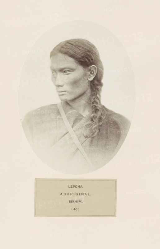 Portrait of an unknown woman from the Lepcha community of Sikkim, photograph, page, inscription: 'LEPCHA., ABORIGINAL., SIKHIM.', number: '(46)', photographer: Benjamin Simpson (possibly), Sikkim, c. 1858 - in or before 1868, paper, albumen print, height 160 mm x width 121 mm, human races, peoples, nationalities, A sepia-toned oval portrait of a person shown from the shoulders up facing left, with long dark hair braided over one shoulder, wearing a textured garment with a strap across the chest, set against a light background within a rectangular page.