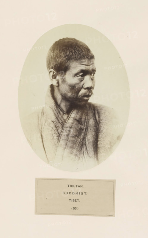 Portrait of an unknown Buddhist man from Tibet, photograph, page, inscription: 'TIBETAN., BUDDHIST., TIBET.', number: '(53)', photographer: Benjamin Simpson (possibly), Tibet, c. 1858 - in or before 1868, paper, albumen print, height 160 mm x width 120 mm, human races, peoples, nationalities, A black-and-white oval portrait of a man shown from the chest up, turned slightly to his left, with short hair and a thin mustache, wearing a textured robe with visible folds and seams; the oval photograph is mounted on a light background with a rectangular label below containing printed lines of text.