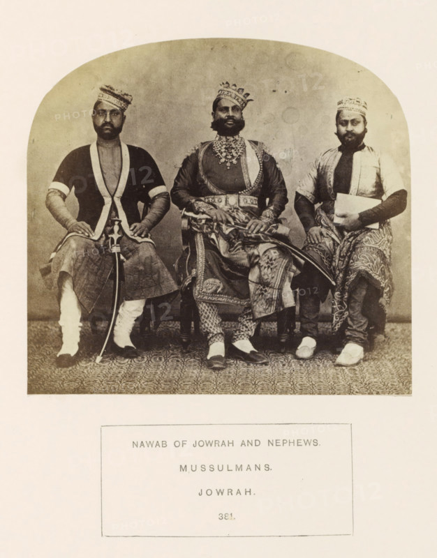 Portrait of Ghous Mahomed Khan, the Nawab of Jaora, with two nephews, Jaora, Madhya Pradesh, India, photograph, page, inscription: 'NAWAB OF JOWRAH AND NEPHEWS., MUSSULMANS., JOWRAH.', number: '381.', photographer: James John Waterhouse (possibly), 1862, Central India, paper, albumen print, height 110 mm x width 118 mm, ruler, sovereign, human races, peoples, nationalities, hacking and thrusting weapons (with NAME), Three seated men wearing patterned turbans and traditional garments occupy the framed photograph, with the central figure wearing ornate layered clothing and heavy jewelry and holding a decorated sword across his lap, while the two men on either side wear simpler tunics and patterned lower garments, one holding a curved sword upright and the other holding a rectangular object; all three have facial hair and neutral expressions, and the floor shows a patterned carpet beneath their feet.