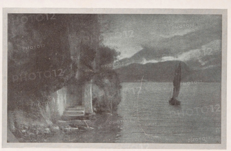 Am Gardasee, View of Lake Garda, page, photomechanical print, monogram: 'BX', inscription: 'Photographische Mitteilungen XL', photographer: A. Richter, Brescia (province), cliché maker: unknown, c. 1898 - in or before 1903, Lombardy, paper, autotype, height 120 mm x width 125 mm, lake, Lago di Garda, A grainy monochrome scene showing a shoreline with a small set of stone steps leading down to the water, dense dark foliage and tree trunks along the left edge, a stretch of calm water extending across the middle, and a small sailboat with a tall dark sail positioned on the water toward the right, under a sky filled with layered clouds and distant low hills on the horizon.