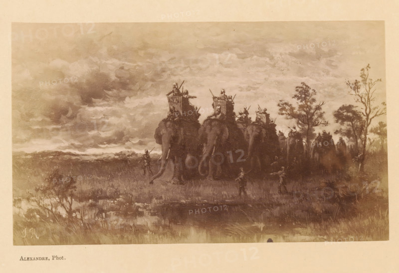 L'Incendie de la Jungle, Photo reproduction of L'Incendie de la Jungle by Jean Baptiste Robie, photograph, reproduction, page, photographer: Alexandre, after painting by Jean Baptiste Robie, c. 1878 - in or before 1883, paper, albumen print, height 92 mm x width 155 mm, behind cover, trunked animals: elephant, forest fire, A sepia-toned landscape showing a line of large elephants seen from behind moving across a grassy plain under a cloudy sky, each elephant carrying a raised platform with figures on top holding long spears or poles, smaller human figures walking alongside and in front of the elephants, scattered trees on the right side of the scene, textured clouds filling much of the upper area and low vegetation in the foreground.