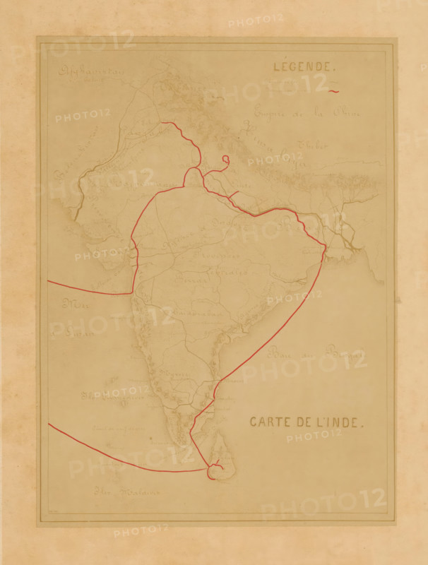 Photo reproduction of a map of India, Carte de l'Inde, photograph, reproduction, page, photographer: Alexandre (possibly), after design by anonymous, c. 1880 - in or before 1885, Alexandre, photographer, after design by, paper, albumen print, height 178 mm x width 131 mm, behind cover., maps of separate countries or regions, India, A faded, sepia-toned map showing a peninsula shape with coastal outlines and interior shading, overlaid with a thin red line tracing routes that cross the land and loop around a southern island; pale, hand-drawn geographical markings and faint contour lines fill the interior, with a double-lined rectangular border near the edges and a blank margin surrounding the map.