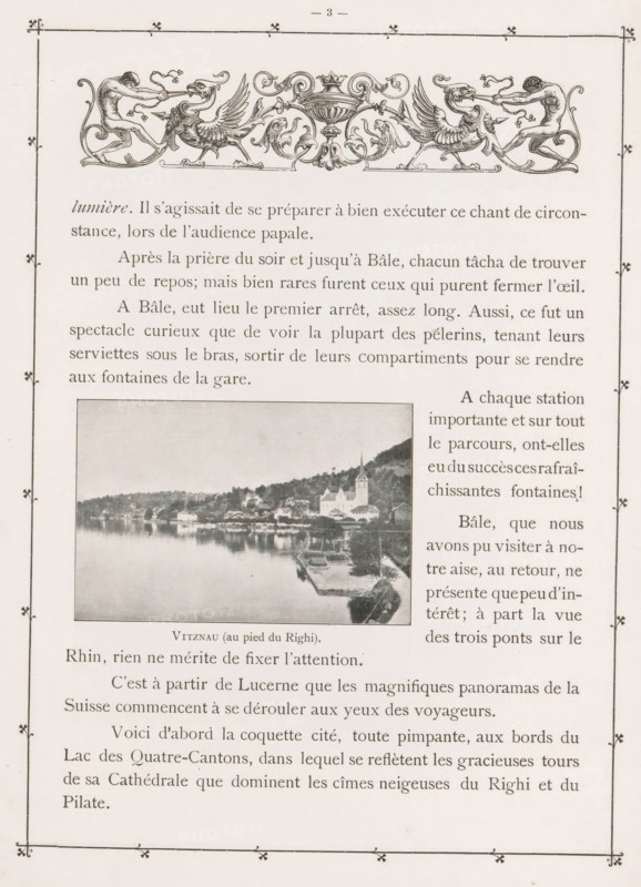 Vitznau (au pied du Righi), View of Vitznau, at the foot of Mount Rigi, page, photomechanical print, cliché maker: Pierre Jumpertz, c. 1893 - in or before 1898, photographer, paper, autotypie, height 60 mm x width 90 mm, city-view in general, 'veduta', mountains, Rigi, A vertically oriented page with a decorative border and an ornate horizontal illustration near the top showing two symmetrical winged mythic creatures facing inward toward a central ornamental vase, flanked by human figures pulling at the creatures; below this is a block of printed lines of text and a rectangular photograph inset showing a lakeside town with buildings, a church with a steeple, tree-covered hills behind, and a calm reflective body of water in the foreground; additional columns of printed lines and more text fill the remaining space of the page.