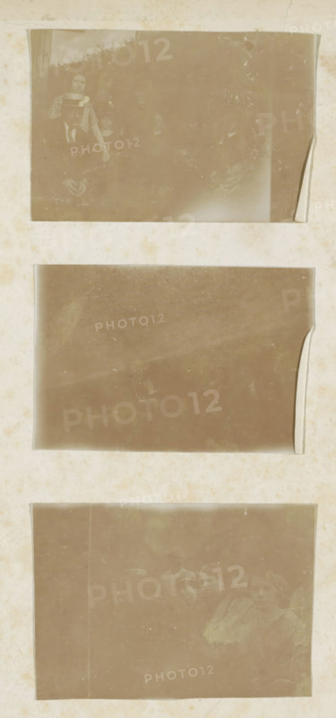 Three group portraits, photograph, page, c. 1875 - c. 1910, photographer, paper, daylight gelatin silver print, height 237 mm x width 155 mm, Photos on inside front cover, anonymous historical persons depicted in a group, in a group-portrait, A vertically oriented page showing three rectangular sepia-toned photographs mounted with light borders on a faded, slightly stained background; the top photograph contains several partially visible people, one wearing a hat and another standing behind, with soft indistinct foliage and a curled corner on the right; the middle photograph is mostly blank and uniformly faded with a rounded peeled edge on the right and faint surface marks; the bottom photograph shows a group of faces and shoulders arranged across the right side, some wearing hats, with the left area darker and smudged and the image overall showing scratches and age-related blemishes.