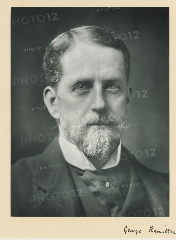 The right honorable Lord George Hamilton, photograph, page, annotation, inscription: '55. Baker St. London, W.', photographer: Elliott & Fry, London, c. 1893 - c. 1903, paper, carbon print, height 226 mm x width 170 mm, Person, Lord George Hamilton, historical persons (portraits and scenes from the life) ((full) bust portrait), A close-up black-and-white portrait of an older man showing his head and upper torso, with neatly combed hair and a full beard and mustache that are lighter in color than his hair, wearing a dark jacket over a vest and a high-collared shirt with a tie; the background is plain and darker than the subject, and a light border surrounds the photograph.