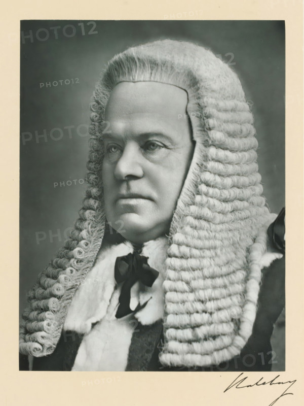 The right honorable the earl of Halsbury, photograph, page, annotation, inscription: '7, Gloucester terrace, Onslow gardens, SW', photographer: Fry & Son, London, c. 1893 - c. 1903, paper, carbon print, height 226 mm x width 170 mm, Person, Hardinge Giffard, wig, historical persons (portraits and scenes from the life) ((full) bust portrait), A black and white portrait of a person wearing a traditional curled wig that frames the face with rows of tight curls along the sides and larger horizontal curls toward the back, a smooth high forehead visible beneath the front of the wig, and a solemn facial expression with softly lit eyes, a straight nose, and closed lips; the person wears a fur-trimmed robe and a dark bow at the neck, and the image has a pale border around it.