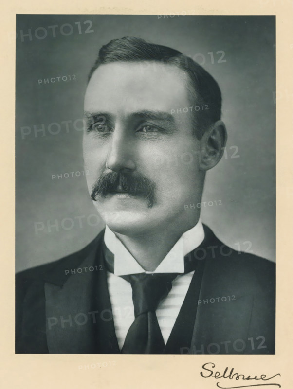The right honorable the earl of Selborne, photograph, page, annotation, inscription: '25, Old Bond St, London, W.', photographer: Bassano & Co., c. 1893 - c. 1903, paper, carbon print, height 228 mm x width 171 mm, Person, William Waldegrave Palmer, historical persons (portraits and scenes from the life) ((full) bust portrait), A black-and-white portrait of a man shown from the chest up, wearing a dark suit jacket over a vest and a high white collar with a dark tie, featuring a neatly groomed mustache and short hair combed to the side, with a neutral facial expression and a plain background.