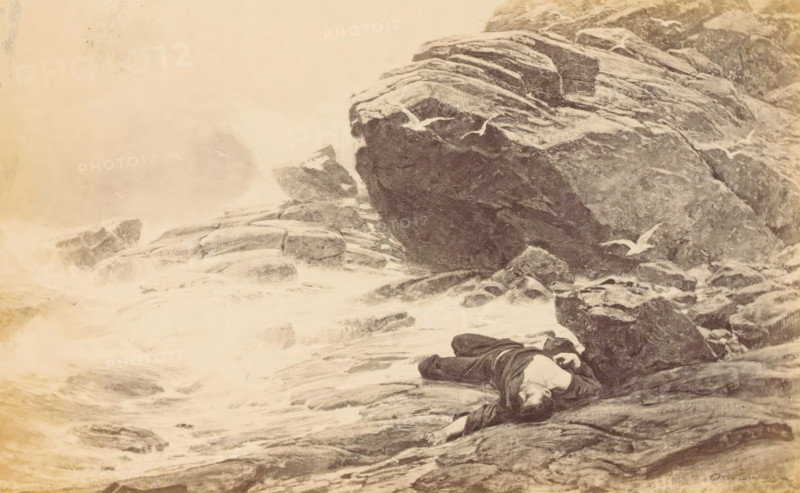 Perdu!', Photographic reproduction of a painting of a man washed ashore on a rocky coast, by Otto Ludvig Sinding, photograph, reproduction, page, photographer: Johannes Jaeger, after painting by Otto Ludvig Sinding, c. 1874 - in or before 1879, Johannes Jaeger, Otto Ludvig Sinding, photographer, after painting by, paper, albumen print, height 121 mm x width 195 mm, adult man, the corpse, rocky coast, A sepia-toned illustration of a rocky shoreline with waves breaking against jagged rocks, showing layered rock formations and foam along the waterline, a figure lying face up on the rocks wearing dark clothing with an exposed chest and an outstretched arm, and several seabirds flying or perched near the rocks, all framed by a wide margin with ruled border lines.