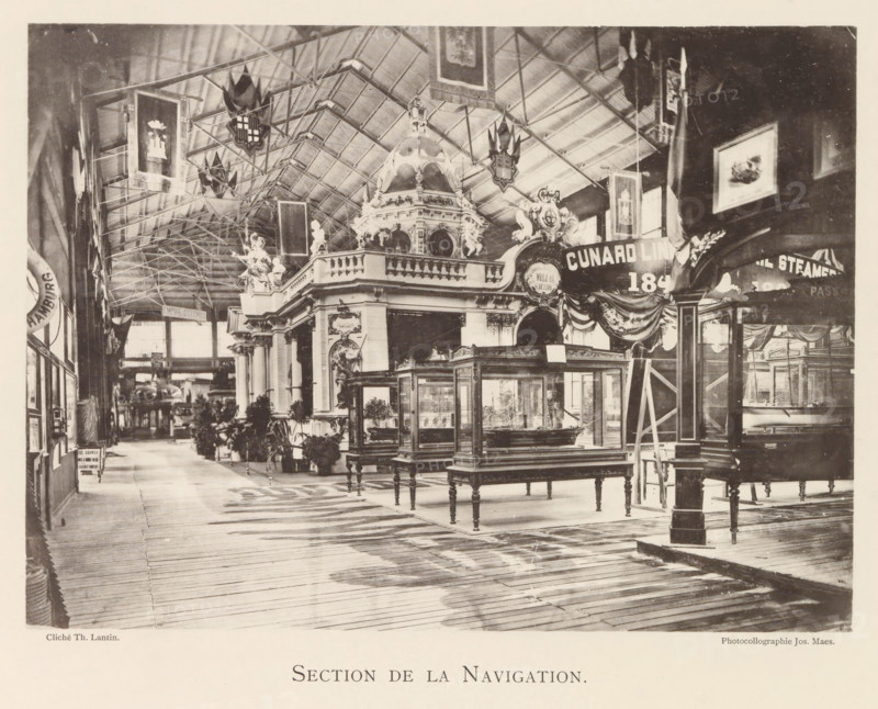 Section de la Navigation, Exhibition of ship models during the World Exhibition in Antwerp, page, photomechanical print, photographer: Th. Lantin, Antwerp, clichémaker: Joseph Maes, 1894, paper, collotype, photoprint, height 160 mm x width 220 mm, ship-model, world fair, world exhibition, exhibition, show, A large indoor exhibition hall with a high arched ceiling supported by visible metal trusses, decorative banners and shields hanging from the rafters, ornate classical architectural structures with sculpted figures and a domed pavilion, glass display cases on wooden legs arranged on a wooden plank floor, potted plants and small trees placed near the displays, framed pictures and additional banners mounted on the walls, a combination of open walkways and partitioned exhibition booths, and various decorative draperies and sculptural details throughout the space.