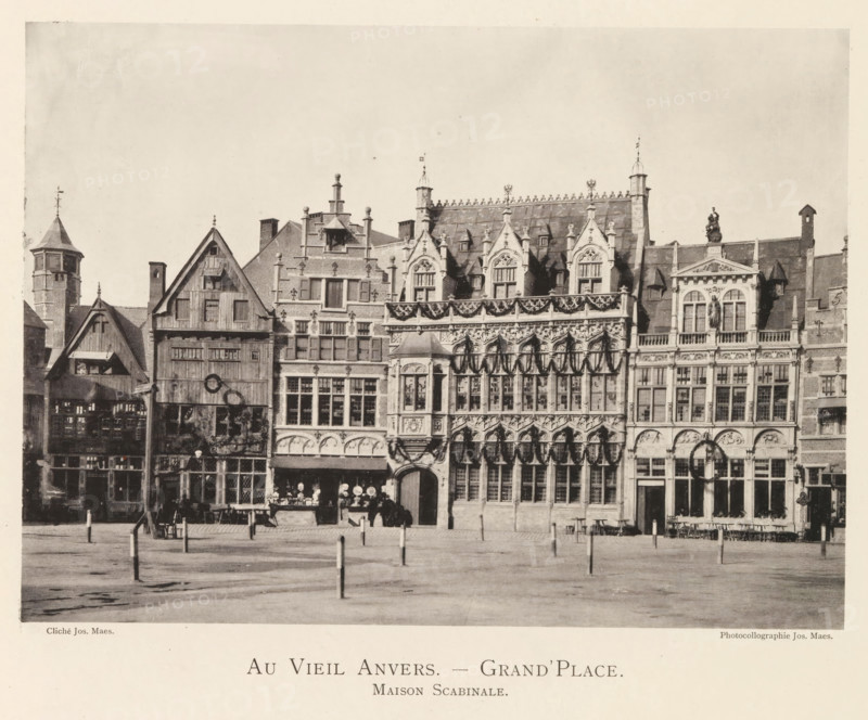 View of the Grote Markt in Antwerp, Au vieil Anvers - Grand'Place. Maison Scabinale, page, photomechanical print, photographer: Th. Lantin, Grote Markt (Antwerp), printer (person): Joseph Maes, c. 1890 - in or before 1894, Th. Lantin, Joseph Maes, photographer, printer (person), Antwerp, paper, collotype, photogravure, height 160 mm x width 220 mm, square, circus, façade (of house or building), A row of ornate historical buildings with varied rooflines and decorative façades facing an open paved square, showing tall narrow windows, carved stone ornamentation, pointed gables, and a mixture of timber and masonry construction; one building features a balcony and sculpted figures, another displays a series of arched doorways and an ornate upper story with patterned stonework, while smaller shopfronts with display windows and awnings occupy the ground level beneath the larger architectural details; the foreground shows a mostly empty plaza with short posts set into the pavement and a few in...
