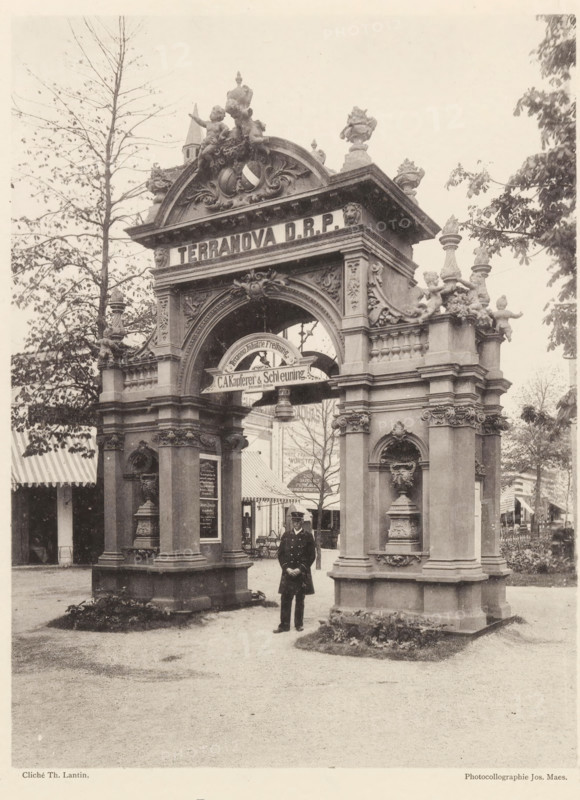 Pavillon au jardin, Gate at the world exhibition in Antwerp, page, photomechanical print, photographer: Th. Lantin, Antwerp, printer (person): Joseph Maes, 1894, printer (person), paper, collotype, photoprint, height 218 mm x width 162 mm, facade (of house or building), gate, entrance, world fair, world exhibition, A sepia photograph of an ornate stone archway with decorative sculptures and reliefs, flanked by two pillars each featuring carved niches and ornamental vases; cherub statues and ornamental finials adorn the top of the arch, and a rounded decorative element sits within the central opening; a man in a dark uniform with a hat stands beneath the arch facing the camera; tents or striped awnings and trees are visible behind and to the sides of the structure, and a gravel or dirt ground extends in front of the arch.