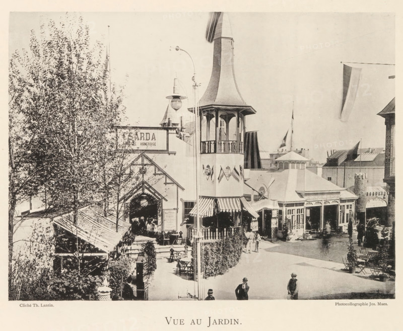 View of the garden, View of the World Exhibition in Antwerp, page, photomechanical print, photographer: Th. Lantin, Antwerp, printer (person): Joseph Maes, 1894, printer (person), paper, collotype, height 163 mm x width 220 mm, façade (of house or building), world fair, world exhibition, World Exhibition 1894 (Antwerp), A sepia-toned outdoor scene showing a row of pavilion-style buildings with decorative roofs and a tall tower with an open upper level and a steep conical roof, striped awnings over entrances, hanging lanterns and flags, and a courtyard area with scattered tables, chairs, and small trees; in the foreground a tree with dense foliage partially obscures structures, several people in period clothing stand or walk in the open space, and architectural details like gables, railings, and rooftops are visible against a pale sky.