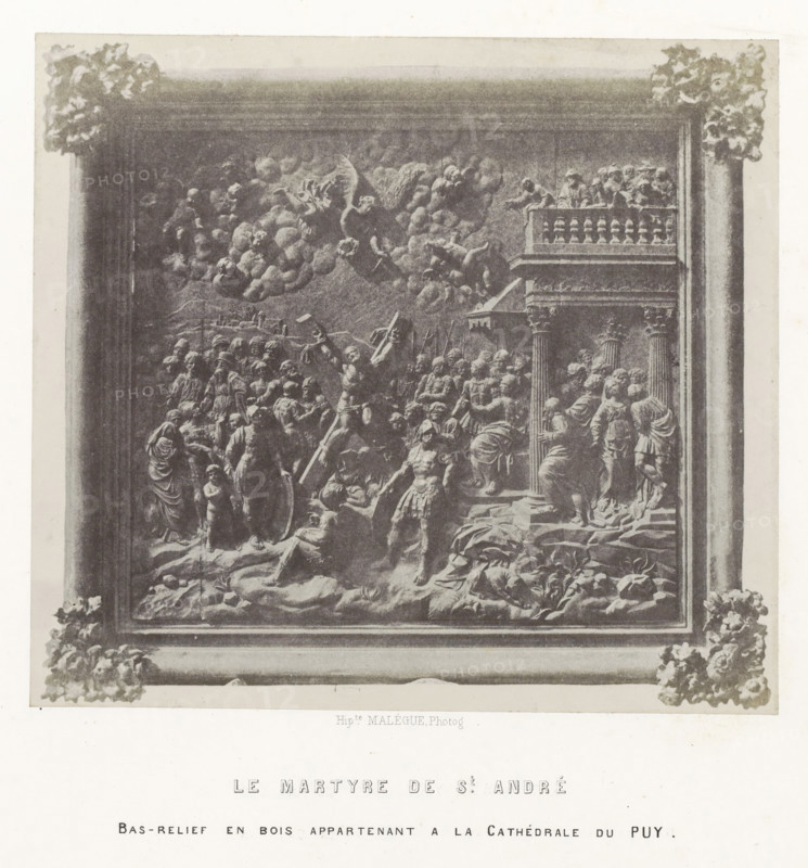 Bas-relief depicting the martyrdom of Saint Andrew, from the cathedral of Le Puy-en-Velay, Le martyre de St. André, photograph, page, inscription: 'Bas-relief en bois appartenant a la Cathédrale du Puy.', number: 'PL. 21.', photographer: Hippolyte Malègue, France, c. 1850 - in or before 1857, paper, salted paper print, height 172 mm x width 191 mm, crucifixion of Andrew: he is undressed and tied to the cross, sculpture (relief, sculpture), A framed grayscale image showing a sculpted scene with numerous human figures in varying poses, some standing and some kneeling, clustered around a central muscular figure who holds a large diagonal object; the scene includes architectural elements such as columns and a balcony with figures leaning over its railing, a background filled with cloudlike formations and small reclining figures, and ornamental floral decorations at the frame corners.
