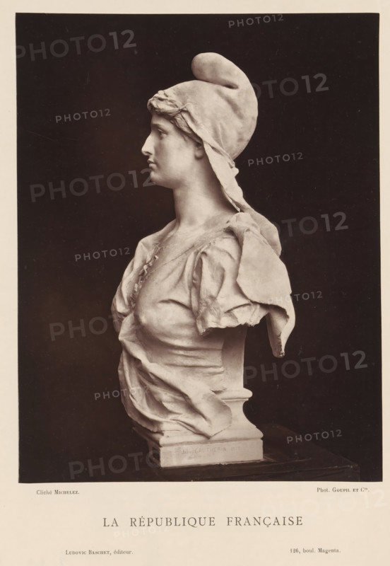 La République Française, Sculpture by Jean Gautherin, depicting a personification of the French republic, page, photomechanical print, inscription: '126, boul. Magenta.', photographer: Charles Michelez, cliché maker: Goupil & Cie., publisher: Ludovic Baschet, c. 1876 - in or before 1879, Jean Gautherin, after sculpture by, paper, Woodburytype, height 240 mm x width 187 mm, piece of sculpture, reproduction of a piece of sculpture, A monochrome photograph of a sculpted bust of a woman shown in profile facing left, wearing a soft cap with a rounded top and a trailing piece of fabric, with short wavy hair visible at the forehead; she has a straight nose, closed lips, and a smooth neck, and is dressed in draped, folded fabric over her shoulders and chest with visible creases and gathers, the sculpture mounted on a rectangular base against a dark plain background with a wide light border around the image.