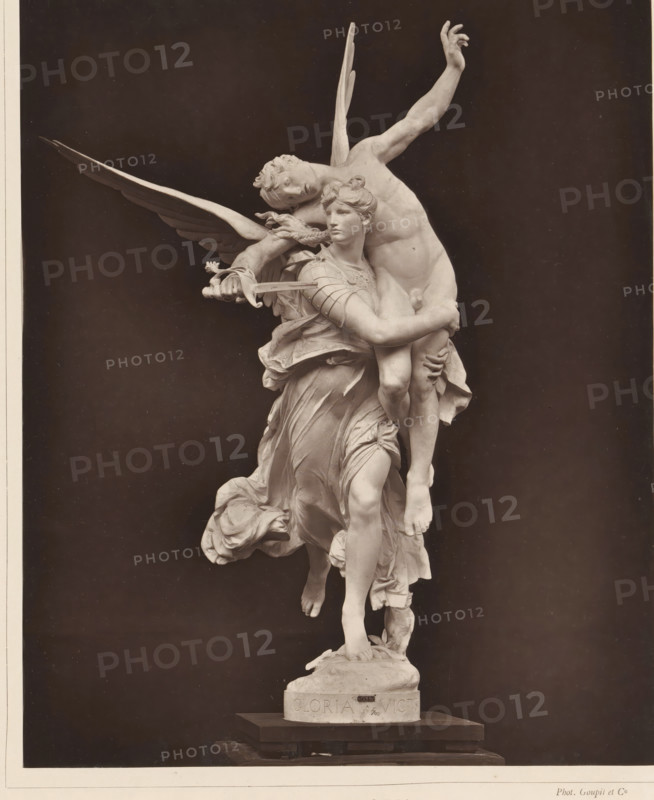 Sculpture Gloria Victis by Marius Jean Antonin Mercié, Gloria Victis!, page, photomechanical print, inscription: '126, boul. Magenta.-Paris.', cliché maker: Goupil & Cie., after sculpture by Marius Jean Antonin Mercié, c. 1876 - in or before 1879, Marius Jean Antonin Mercié, photographer, after sculpture by, paper, Woodburytype, Woodburytypie, height 240 mm x width 193 mm, piece of sculpture, reproduction of a piece of sculpture, angels, A monochrome photograph of a detailed marble sculpture depicting two human figures entwined in a dynamic pose against a dark background; one figure has large outstretched wings and holds a sword while embracing the other figure who appears to be partially draped in flowing garments, with one leg lifted and the other foot resting on a rounded base; the sculpted faces show calm expressions and the hair, musculature, and folds of the clothing are finely carved; the base of the sculpture sits on a stepped plinth.