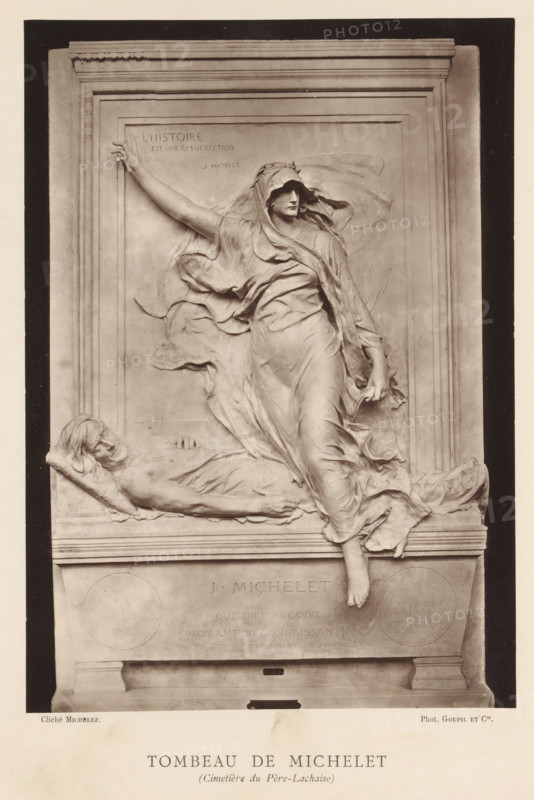 Tomb for Jules Michelet by Marius Jean Antonin Mercié, Tombeau de Michelet (Cimetiere du Pere-Lachaise), page, photomechanical print, inscription: '126, boul. Magenta.-Paris.', photographer: Charles Michelez, cliché maker: Goupil & Cie., after sculpture by Marius Jean Antonin Mercié, publisher: Ludovic Baschet, c. 1876 - in or before 1879, Marius Jean Antonin Mercié, after sculpture by, paper, Woodburytype, Woodburytypie, height 257 mm x width 182 mm, grave, tomb, Paris, Cimetière du Père-Lachaise, A sculpted relief set within a rectangular stone frame shows a draped female figure stepping forward with one arm extended upward and the other lowered, her flowing garments creating sweeping folds and billows around her body and head. At her feet and leaning against the base, a reclining male figure lies on a cushion with his head turned to the side and one hand resting on his chest, his form partially covered by drapery. The relief includes an architectural surround with molded edges and a...