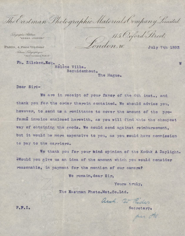 Letter to Philip Zilcken, letter, writer (clerical worker): Eastman Photographic Materials Company Ltd, London, writer (clerical worker): Asch. W. Rider, 1893-07-07, writer (clerical worker), materials by function, paper, ink, typewriting, writing (processes), pen, printing, height 425 mm x width 425 mm, money, photography, cinematography, A faded sheet of paper with a printed letterhead at the top featuring ornate cursive text and smaller printed lines, a typed body of text in purple ink occupying the upper and middle areas, several small smudges and creases across the page, a blue handwritten signature toward the lower right, and a small stamped marking in purple near the bottom left.