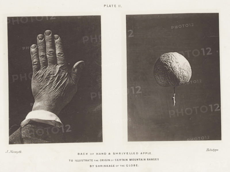 Back of Hand & Shrivelled Apple. To illustrate the origin of certain mountain ranges by shrinkage of the globe, page, photomechanical print, Left the wrinkled back of a hand, right a shriveled apple., number: 'Plate II.', photographer: James Nasmyth, London, cliché maker: anonymous, United Kingdom, c. 1870 - in or before 1873, paper, collotype, photoprint, height 215 mm x width 280 mm, Print for page 31., fruits: apple, hand (back view), A grayscale image divided into two dark rectangular panels separated by a light vertical strip, the left panel showing the back of a hand with visible wrinkles and short fingernails, a cuff and sleeve at the wrist, and the right panel showing a spherical, textured object suspended above a thin stem against a dark background.