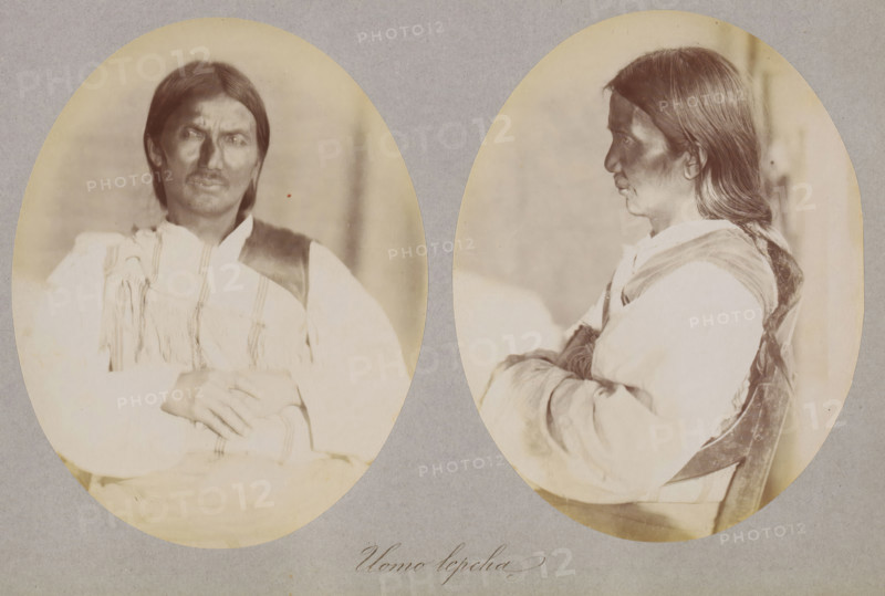 Two portraits of an unknown man of the Lepcha, Uomo lepcha, photograph, page, photographer: Paolo Mantegazza, India, c. 1881 - in or before 1886, paper, albumen print, height 151 mm x width 241 mm, adult man (side view, profile), Two oval sepia-toned portraits of the same person are mounted on a gray background, one showing a frontal three-quarter view and the other a profile facing right; the person has long dark hair parted in the middle, a mustache, and a somber facial expression, wearing a light-colored shirt with fringed decoration and a darker vest, with arms folded across the torso in both images and subtle shadows on the face and clothing.