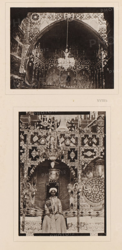 Two views of a rikah in Mecca, one with an unknown groom, Two different Aufnahmen der Rikah, des Thronsessels, auf welchen man in Mecca who pflegt young frauliche Braut in the Duchlah-nacht zu erheben, album page, photomechanical print, Deze print is part of an album., number: 'XVIIIa, The image shows two vertically arranged black-and-white photographs on a light background. The top photograph depicts an arched interior with ornate patterned walls and a central hanging chandelier, visible decorative round motifs on the walls, and intricate ornamental detailing around the arch. The bottom photograph shows a seated figure wearing a turban and long garment on a decorated throne-like seat beneath an ornate canopy, surrounded by elaborately patterned panels, hanging chandeliers, decorative columns, and circular ornamental elements on either side.