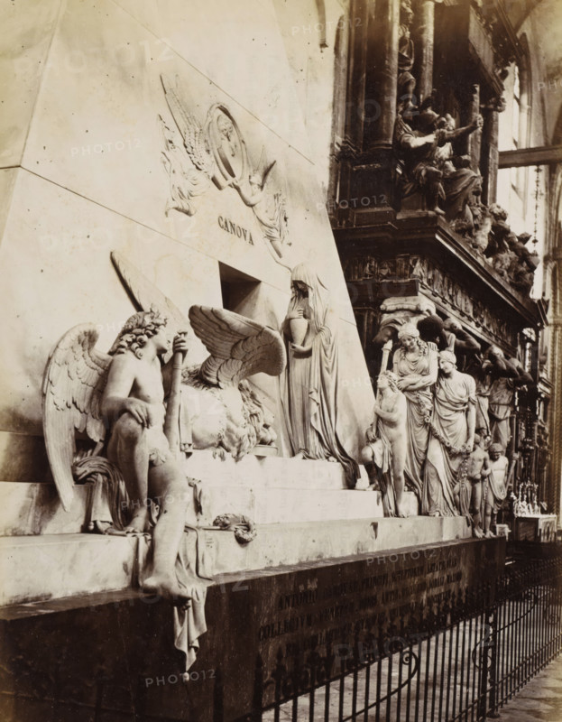 Tombeau du Sculpteur Canova, Venezia - Monumento Canova ai frari, Monument to Canova in the Basilica di Santa Maria Gloriosa dei Frari in Venice, photograph, Part of Topographical album of Venice 1881., negative number: '234', check stamp: 'Carlo Ponti Venezia', photographer: Carlo Ponti, Venice, 1860 - 1881, paper, albumen print, albumendruk, height 259 mm x width 199 mm, piece of sculpture, reproduction of a piece of sculpture, monument, statue, travel, Basilica di Santa Maria Gloriosa dei Frari, A stone funerary monument fills the left and center of the image, featuring several carved figures in classical style including winged figures, a reclining winged lion, a robed veiled woman holding an urn, and standing draped women and children arranged along a stepped base; the stone surface shows smooth panels and bas relief decorations. To the right a darker, ornate architectural structure with columns and additional sculpted figures rises, creating contrast with the pale monument. In the...