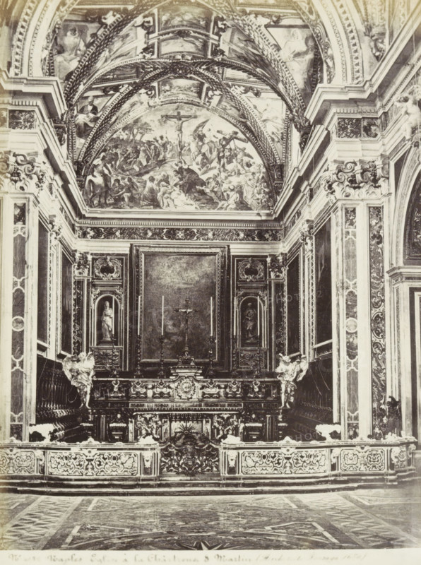 Church of the Monastery of San Martino in Naples, Naples Eglise à la Chartreuse S. Martin (Architecto Fanzago 1670), photograph, Part of Travel album with photos of sights in Naples and surroundings., negative number: '40...', Naples, c. 1865 - c. 1875, photographer, paper, albumen print, albumendruk, height 246 mm x width 185 mm, interior of church, altar, The image shows an ornate interior with a richly decorated altar area framed by carved columns and panels, a central altarpiece with a crucifix and tall candlesticks, sculpted figures flanking the altar, and elaborate reliefs and ornamentation covering the walls and balustrade; above the altar a vaulted ceiling features painted scenes and decorative arches, and the patterned floor in front extends toward the viewer.