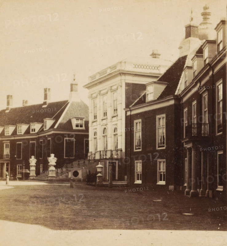 Hague, Huis ten Bosch, View of Huis ten Bosch Palace in The Hague, stereograph, The Hague, 1873 - 1890, photographer, pasteboard, paper, albumen print, albumendruk, height 85 mm x width 169 mm, palace, Huis ten Bosch Palace, A sepia-toned photograph showing a row of grand buildings with varying rooflines and architectural details, including steep tiled roofs with dormer windows, a flat-roofed section with a balustrade, and a taller building with columns and arched windows; stone steps lead up to an entrance flanked by ornate sculpted urns on pedestals, and there are decorative railings along the steps and balconies; the facades display rectangular windows with trim and sash divisions, and one corner of the scene shows a colonnaded portico with tall columns; the foreground is an open paved courtyard with subtle textures and wear.