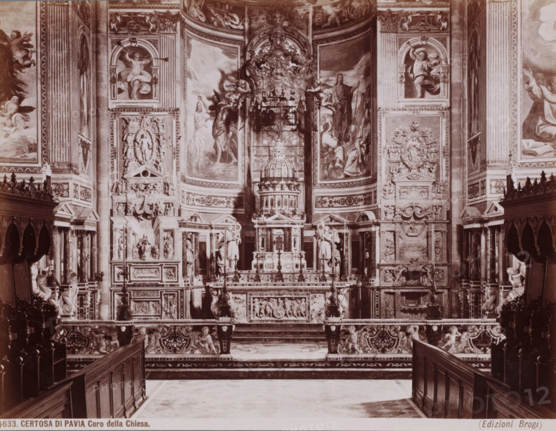 Coro della Chiesa, Interior of the Certosa di Pavia, seen towards the choir, Pavia, Italy, Certosa di Pavia, photograph, number: '1633.', number: '13', publisher: Giacomo Brogi, Florence, 1856 - 1881, photographer, Tuscany, Lombardy, pasteboard, paper, albumen print, height 304 mm x width 404 mm, parts of church interior: choir, A wide interior view of an ornate church choir area dominated by a richly decorated altar and backdrop, with carved stone and sculpted figures, relief panels, and architectural moldings covering the walls; tall painted panels and frescoes depicting human figures and angelic forms flank the central dome-like structure above the altar, while intricately carved balustrades, ornate benches, and wooden pews frame the foreground; sculpted cherubs and ornamental motifs appear along the lower railing and supports, and decorative columns, pilasters, and niches filled with statues rise on either side, all rendered in a monochrome sepia tone.