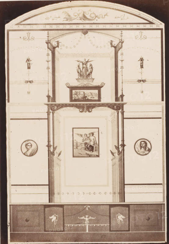 Photo reproduction of a fresco in the house of Marcus Lucretius on Via Stabiana in Pompeii, Italy, photograph, reproduction, inscription: 'Victoire paris maison Marc Lucrete', inscription: '83-', number: '11', Pompeii, after painting by anonymous, 1851 - 1900, photographer, pasteboard, paper, albumen print, albumendruk, height 404 mm x width 306 mm, picture, painting, wall-covering, Via di Stabia, A tall vertical architectural panel rendered in sepia tones shows an ornate interior elevation with decorative moldings and pilasters framing a recessed central section, topped by an arched pediment with scrolling motifs and small ornamental figures. Within the upper central niche sits a sculptural group of a standing female figure flanked by two animals atop a plinth, and below it a framed landscape-like panel. The central recessed wall displays a framed figurative scene depicting a seated figure with an angelic figure beside, bordered by narrow decorative bands and small floral motifs. Flan...