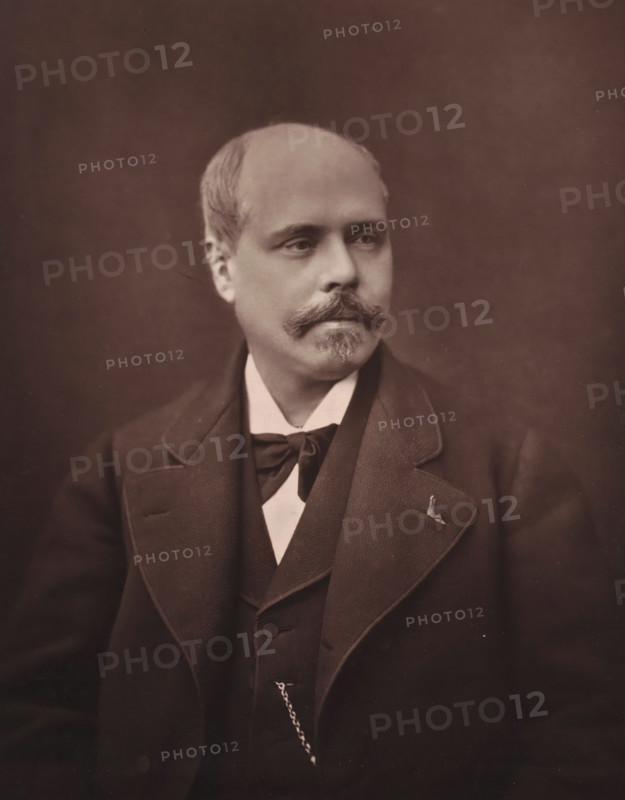 Adolphe Belot, Portrait of Adolphe Belot, page, photomechanical print, inscription: 'Galerie Contemporaine, 126, boul. Magenta. - Paris., (Né a La Pointe-a-Pître, en 1830)', photographer: Ferdinand Mulnier, cliché maker: Goupil & Cie., 1874 - 1879, paper, Woodburytype, Woodburytypie, height 230 mm x width 186 mm, Person, historical persons, adult man, A sepia portrait of a man shown from the chest up wearing a dark suit with wide lapels, a vest, and a bow tied at his collar, his hair is short and receding, he has a neatly groomed mustache and small goatee, his expression is neutral as he looks slightly to his left, a small pin is visible on his left lapel and a watch chain hangs from his vest, the background is plain and evenly toned.
