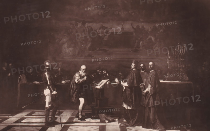 Reproduction of Galilée devant le Saint-Office by Joseph-Nicolas Robert-Fleury, Galilée devant le Saint-Office (Collection Pillet-Will), reproduction, page, photomechanical print, inscription: 'Galerie Contemporaine, Ludovic Baschet, éditeur., 126, boul. Magenta.', cliché maker: Goupil & Cie., after design by Joseph Nicolas Robert-Fleury, c. 1874 - in or before 1879, photographer, paper, Woodburytype, height 158 mm x width 249 mm, New Testament, painting, drawing and the graphic arts, A dimly lit scene shows a group of men gathered in a grand interior with a patterned floor and a raised table or altar at the back. In the foreground a bearded man in period clothing stands at a lectern with an open book, facing a row of formally dressed men, some wearing robes and one in a helmet and armor holding a long staff or spear. Several books and papers lie on the floor near the lectern. Behind the central figures, other seated and standing figures form a shadowed audience, and a tall ornate cand...