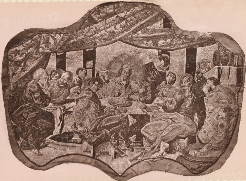 Part of a silk embroidery depicting the Last Supper, A piece of silk embroidery, representing the 'Lord's Supper', page, photomechanical print, number: 'No. 680.', inscription: 'Lent by Monsieur Spitzer.', photographer: Isabel Agnes Cowper, United Kingdom, cliché maker: anonymous, after design by anonymous, c. 1869 - in or before 1874, Isabel Agnes Cowper, photographer, cliché maker, after design by, paper, Woodburytype, height 150 mm x width 215 mm, (other forms of) needlework, eg: crocheting, knitting, embroidering, A monochrome depiction shows a group of people gathered around a long table beneath a patterned draped canopy. Figures with varied hairstyles and facial hair are seated closely, some leaning, some reclining, many with eyes closed or looking downward. One central figure has a radiating halo-like pattern around the head. Plates and bowls with food rest on the table, and hands reach toward them. Drapery and textured fabrics cover the floor and the figures, with folds and lay...