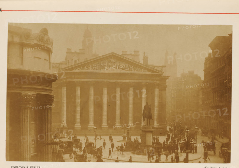 View of the Royal Exchange in London, View of the Royal Exchange, photograph, page, inscription: 'POULTON'S SERIES., To face p.210.', photographer: Poulton, London, c. 1870 - c. 1890, Poulton, photographer, paper, albumen print, height 88 mm x width 143 mm, street, Exchange, Bourse, Royal Exchange (1844-1939), A sepia-toned street scene showing a large classical building with a triangular pediment decorated with sculpted figures and a row of tall columns along its facade, a mounted statue on a high plinth positioned in front of the building, a crowd of people and numerous horse-drawn carriages gathered in the open area before the steps, flanked by multi-story buildings lining the street on the right and a rounded columned structure visible on the left, with lampposts and distant towers faintly visible through a hazy atmosphere.