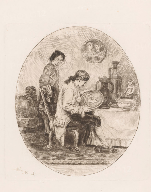 Art lover studies antique porcelain and earthenware, print, printmaker: Willem Linnig (II), 1881, paper, etching, drypoint, intaglio printmaking technique, etching and drypoint with plate tone, height 221 mm x width 202 mm, art collector, An oval etching shows two young men in period clothing inside a room furnished with decorative objects; one man sits on a small carved stool, head bowed and holding a circular plate with a face motif while wearing a loose coat and stockings, his shoes beside him on the floor, and the other man stands behind him leaning on the back of a chair draped with a patterned cloth, looking toward the seated figure. A draped table beside them holds several vessel-shaped objects including a tall jug with a handle, a large amphora, a bowl, and a small seated statuette. On the wall above the table hangs a round plaque depicting two faces in profile. The floor beneath them shows a patterned rug and the background is filled with closely hatched lines.