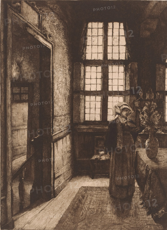 Lady in an interior arranging flowers, print, mark: 'Antwerpsche Etsers 1880', printmaker: Léon Brunin, 1886, paper, etching, intaglio printmaking technique, height 360 mm x width 239 mm, interior of the house, flowers in a vase, A dimly lit interior rendered in fine linework showing a narrow entry area with wooden paneling and a patterned rug along the floor, a tall multi-paned window casting light into the space, a doorway opening into another room, and a figure standing near a table holding a vessel of flowers; the figure wears a long coat and a head covering and appears to hold a small object near a piece of furniture beside the window, while a carved mantel and decorative objects sit near the window and the table is draped with a cloth.