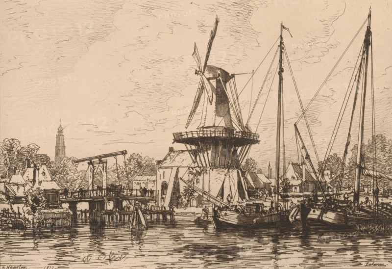 View of Haarlem, 1877, À Haarlem (Hollande), print, printmaker: Maxime François Antoine Lalanne, France, printer (person): François Liénard, Paris, printer (person), paper, etching, intaglio printmaking technique, drypoint, etching with drypoint and plate tone, height 230 mm x width 315 mm, Published in L'Art in 1878., city-view, and landscape with man-made constructions, water course, Haarlem, A detailed pen-and-ink scene shows a waterfront with a large traditional windmill on a raised circular base and long sails, surrounded by buildings with pitched roofs and trees, a bridge structure with supporting beams, several tall masts and rigging from moored boats along the water, reflections rippling on the water surface, and a sky filled with lightly sketched clouds.