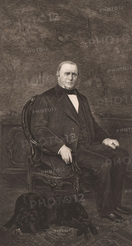 Portrait of an unknown man, possibly Senator Van den Berge Elsen, print, annotation: 'dernier état de la planche', printmaker: Frans Lauwers (signed by artist), 1864 - 1911, paper, etching, intaglio printmaking technique, height 349 mm x width 195 mm, historical persons, A monochrome engraving of a seated older man with sideburns wearing a dark suit, waistcoat, white shirt, and bow tie, sitting in an ornate wooden chair with carved details; his left hand rests on the arm of the chair and his right hand rests on his knee. The background shows textured shading and a paneled wall behind him. On the floor in front of the chair lies a dark-coated dog with its head down. The overall image is detailed with fine crosshatching and line work.