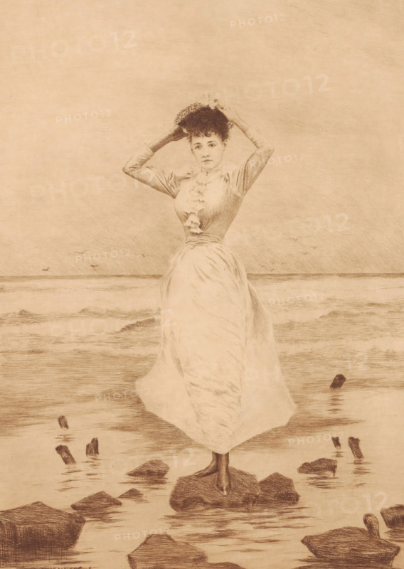 Mouettes, Young woman on a stone in the surf, print, printmaker: Léon Lowenberg (signed by artist), c. 1875 - in or before 1912, paper, etching, drypoint, intaglio printmaking technique, etching and drypoint with plate tone, height 366 mm x width 258 mm, A sepia-toned drawing of a woman standing on a rock at the water's edge, wearing a long flowing dress with a fitted bodice and ruffled front, holding a hat above her head with both hands; the scene shows gentle waves in the background, scattered rocks and wooden posts emerging from the shallow water, and a distant horizon line under a textured sky.
