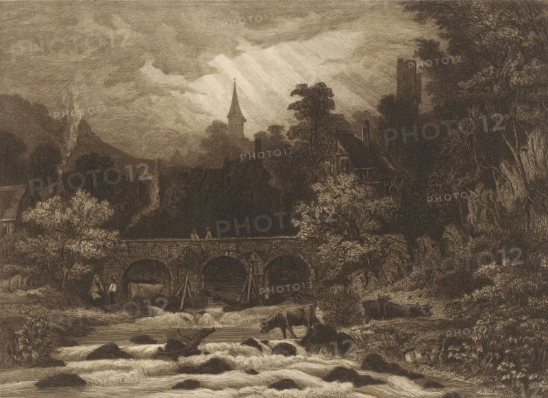 Landscape with village in a mountain valley along a river with bridge, print, printmaker: Auguste Numans (signed by artist), 1833 - 1879, paper, etching, intaglio printmaking technique, roulette, height 197 mm x width 275 mm, prospect of village, silhouette of village, bridge in village across river, canal, cow, river (landscape with figures, staffage), A sepia-toned engraved landscape showing a stone arched bridge spanning a flowing river with rapids and rocks in the foreground, a cow standing on a rocky bank and other cattle in the water, two figures near the riverbank and one standing on the bridge, trees with dense foliage flanking the scene, timber-framed houses and chimneys partially obscured by trees behind the bridge, a church steeple and a square tower rising above the treeline, streaks of light breaking through heavily textured clouds, and smoke rising from a distant chimney.