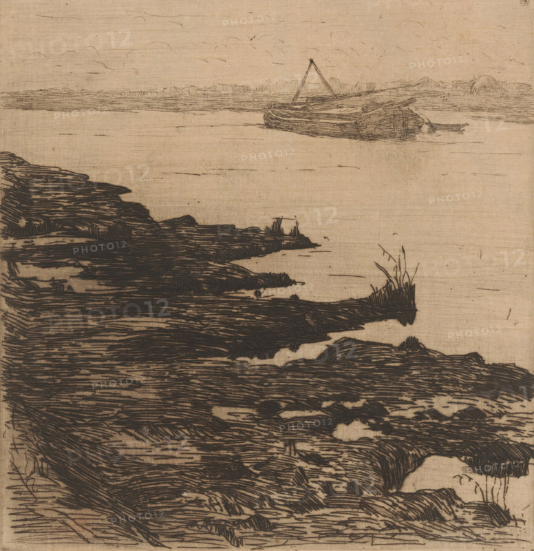 River with boat, print, printmaker: Maurits van der Valk (signed by artist), 1867 - 1914, paper, etching, drypoint, intaglio printmaking technique, height 179 mm x width 174 mm, freight vessel, river, A sepia-toned drawing shows a shoreline with dark, hatched rock formations in the foreground extending toward the water, sparse tufts of grass on some rock edges, a calm water surface with light horizontal strokes, and a small boat with a simple mast resting on the water near the horizon under a sky sketched with faint, curved cloud lines.