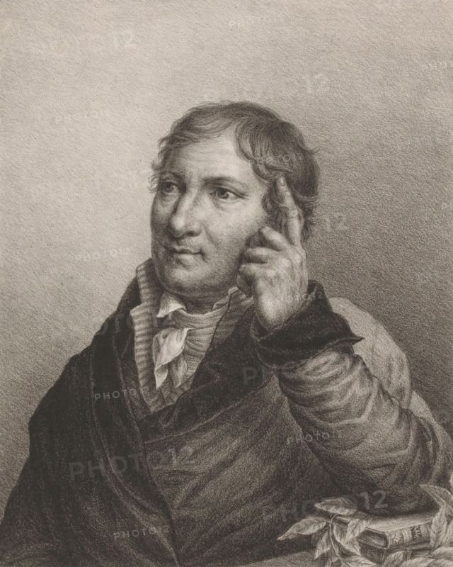 Portrait of Christoph August Tiedge, print, The sitter has his left hand near his head and rests his elbow on a pile of books and leaves., printmaker: Maas (engraver), printer (person): Königliches Lithographisches Institut, Berlin, publisher: Carl Gottfried Lüderitz, 1824, printer (person), paper, lithography, height 310 mm x width 230 mm, Person, Christoph August Tiedge, historical persons ((full) bust portrait), head held in the hand(s), with elbows leaning on an elevation or on the knees, A monochrome portrait of a person shown from the chest upward, rendered in fine textured shading, with short wavy hair and a contemplative expression; the person is looking slightly to the side and has one hand raised with fingers touching the side of their head; they wear layered clothing including a collared shirt with a loosely tied scarf and a heavy outer garment with visible folds and drapery; the background is a uniform, softly textured tone.