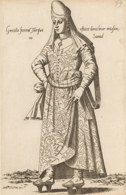 Gentille femme Turque estant dans leur maison ou sarail, Turkish woman, print, album page, book illustration, Print is part of an album., printmaker: Léon Davent, after drawing by Luca Penni (attributed to), after drawing by Nicolas de Nicolay (possibly), publisher: Guillaume Rouille (I), Lyon, 1555 - 1568, Attributed to, paper, etching, pasted on album page, height 272 mm x width 173 mm, A monochrome engraved depiction of a standing woman wearing a long patterned robe with floral motifs and a fitted jacket, a shawl draped over her head and shoulders, and a rounded headdress; she has a beaded necklace with a pendant and earrings, and her hands rest on her hips with one hand sliding into a sash at her waist; the robe falls to the ground revealing heeled wooden sandals with straps and raised platforms, and the ground beneath her shows textured shading suggesting grass or earth.