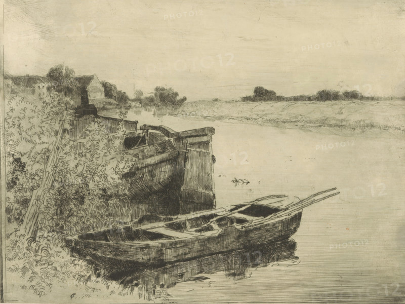 River with boats at the waterside, print, printmaker: Cornelis Vreedenburgh, 1890 - 1946, paper, etching, intaglio printmaking technique, height 146 mm x width 197 mm, rowing-boat, canoe, sailing-ship, sailing-boat, river, A wide, shallow riverbank scene rendered in fine, dark line work shows several wooden rowboats pulled up on the shore, their hulls and internal planks visible, with oars resting across one of them. Dense foliage and leafy plants grow along the left edge, interspersed with a leaning wooden post or rail. Behind the vegetation, low buildings with sloped roofs and clustered trees recede into the distance. The calm water stretches toward a flat horizon with distant treelines and marshy grasses, and the sky above is pale and largely empty, textured with subtle horizontal and faint diagonal lines.