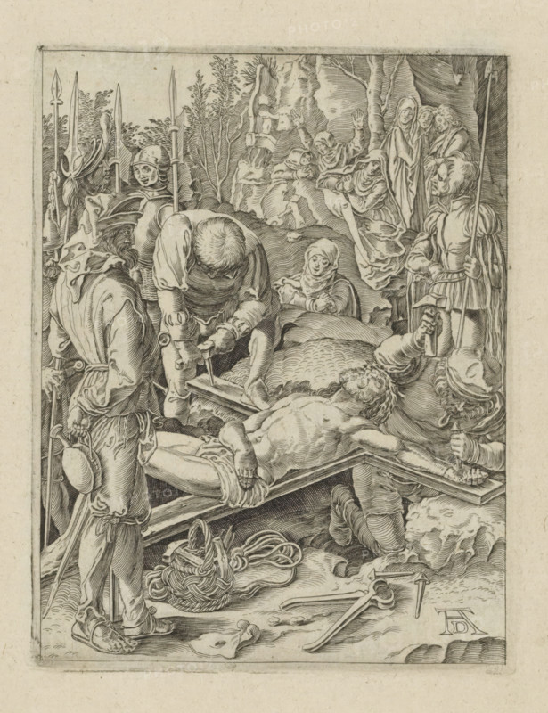 Christ nailed to the cross, Passio Christi Ab Alberto Durer Nurenburgensi Effigiata, The Little Passion, print, album page, Christ is nailed to the cross. Print is part of an album., printmaker, after print by, publisher, The Hague, paper, engraving, engraving pasted onto album page, height 131 mm x width 100 mm, the erection of the cross: Christ is nailed to the cross which lies on the ground, A detailed black and white engraving shows a group of armored soldiers and robed figures surrounding a reclining, partially nude man on a wooden bed or bier, with one soldier kneeling and using a tool near the man's torso while another holds a hammer and nail above the foot area. The foreground contains coiled rope, a hat on the ground, scattered tools, and a soldier standing with a pole weapon and a small round canteen at his side. Behind the central scene there are trees and draped cloth, and several women in flowing robes display varied gestures and facial expressions as they look toward the ...