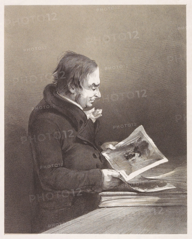Portrait of artist Joseph Mallord William Turner, print, Portrait of artist Joseph Mallord William Turner viewing a print in the print cabinet of the British Museum., annotation: 'JMW Turner, Proof before letters, Drawn in the print room of the British Museum, Published by MM Holloway, Covent Garden', printmaker: Louis Haghe, London, after design by John Thomas Smith, publisher: Marseille Holloway (possibly), 1823 - 1852, paper, tone lithography, lithography in black with tone block in beige, proof print, height 471 mm x width 350 mm, Person, Joseph Mallord William Turner, portrait, self-portrait of artist, eg: engraving, etching, lithograph, British Museum, A monochrome drawing of a man in profile seated at a table, wearing a dark coat with a high collar and a light-colored neck cloth, his hair unkempt and his face turned down toward a sheet of paper he holds, the paper showing shaded illustrations and resting above a stack of other papers on the table.
